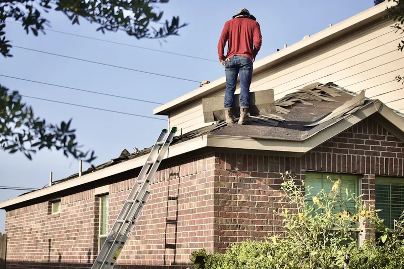 Professional roofer working on a residential roof in East Brandywine